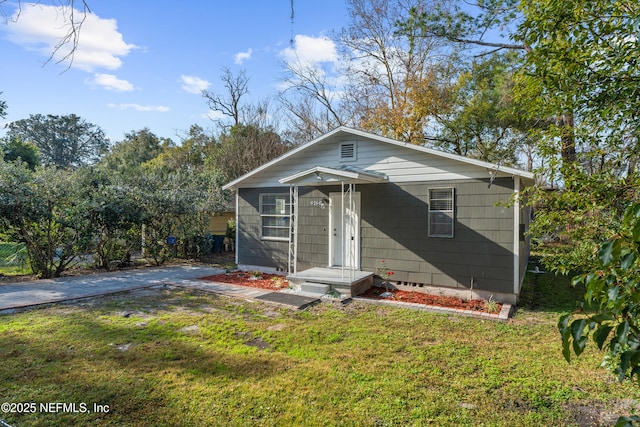 bungalow-style house with a front lawn