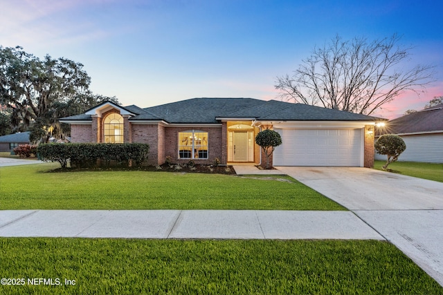 single story home featuring a yard and a garage