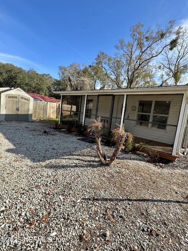 rear view of property with a shed