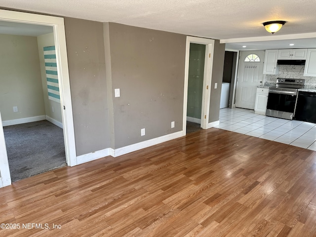 kitchen with white cabinetry, black dishwasher, backsplash, electric range, and light wood-type flooring