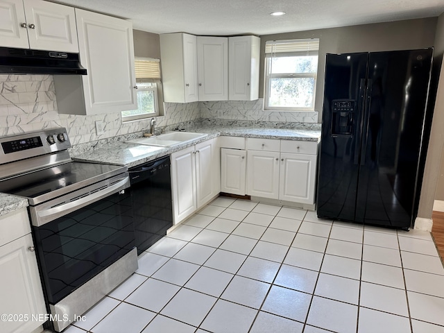 kitchen with white cabinetry, light tile patterned floors, sink, and black appliances