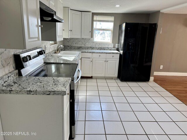 kitchen with black fridge with ice dispenser, sink, stainless steel range with electric cooktop, and white cabinets