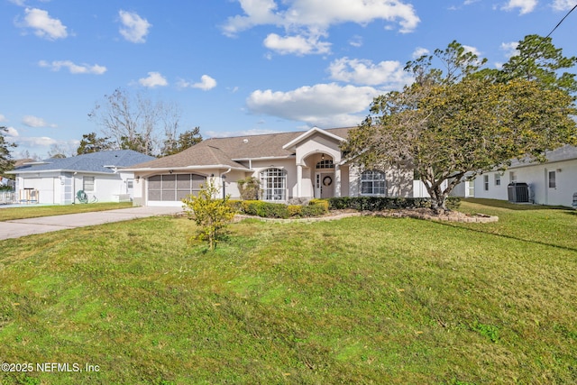 ranch-style house with cooling unit and a front lawn