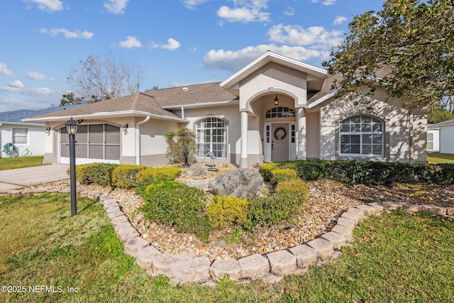 single story home with a garage and a front yard