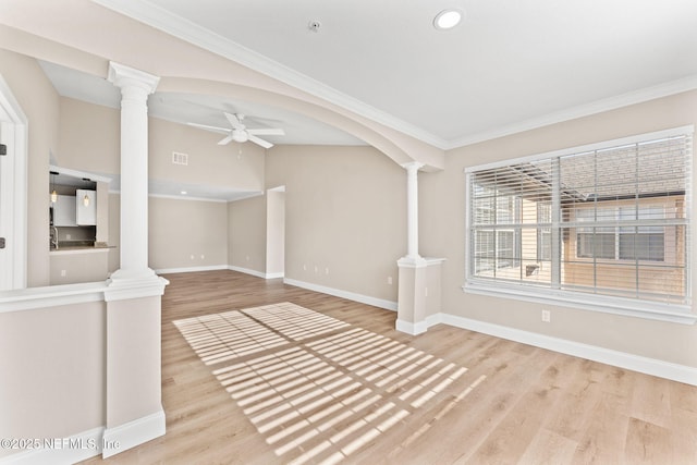 unfurnished living room with ceiling fan, decorative columns, and light wood-type flooring