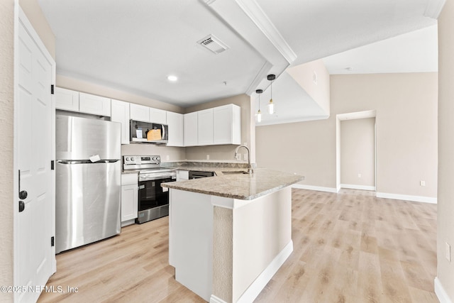 kitchen featuring sink, white cabinetry, light stone counters, pendant lighting, and stainless steel appliances