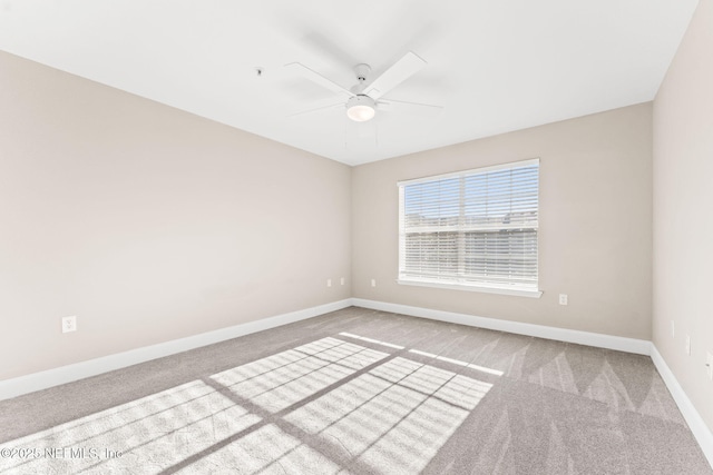 carpeted spare room with ceiling fan