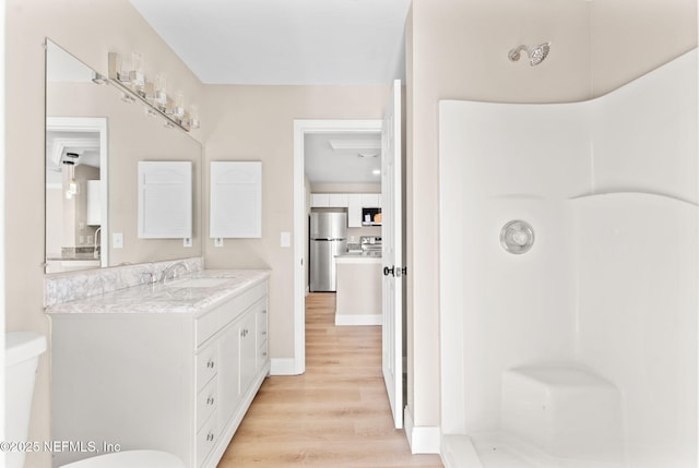 bathroom featuring vanity, hardwood / wood-style floors, and toilet