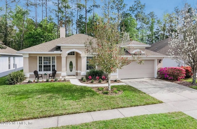 view of front of house featuring a garage and a front lawn