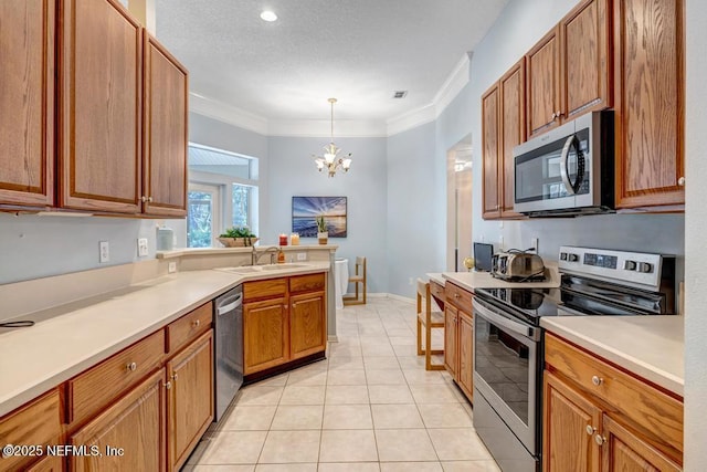 kitchen featuring sink, light tile patterned floors, stainless steel appliances, ornamental molding, and decorative light fixtures