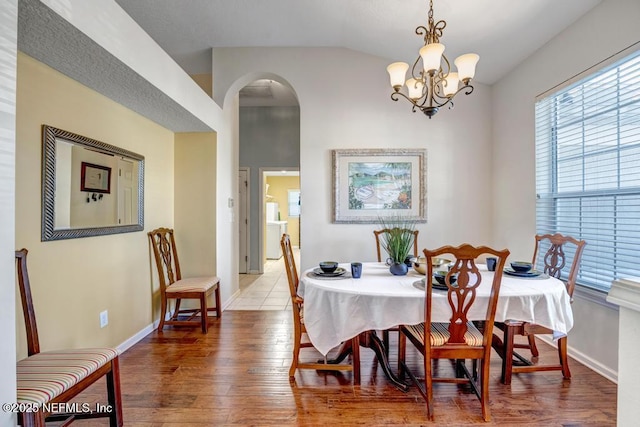 dining room with hardwood / wood-style flooring and a notable chandelier