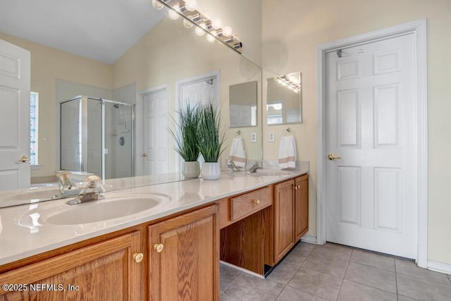 bathroom featuring vanity, a shower with shower door, and tile patterned flooring