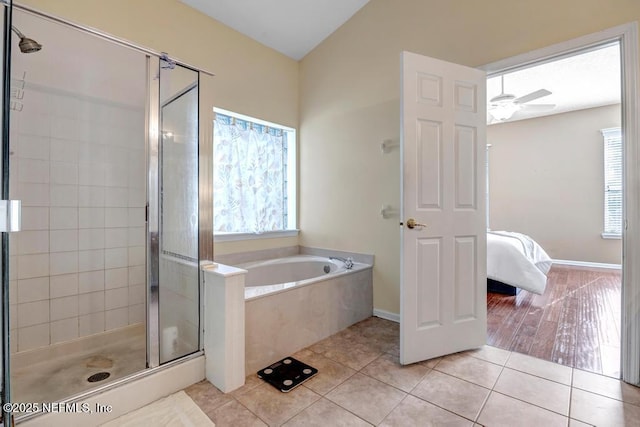 bathroom with ceiling fan, tile patterned floors, a healthy amount of sunlight, and separate shower and tub