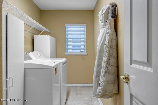 laundry room featuring light tile patterned floors and washing machine and clothes dryer