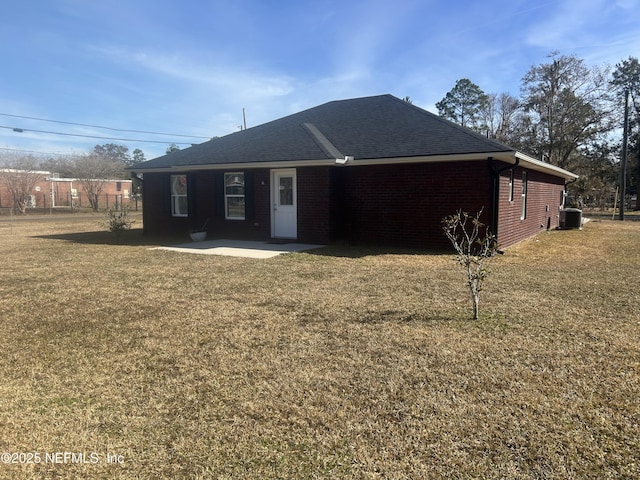 back of house featuring a yard, central AC, and a patio area