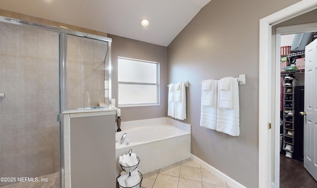 bathroom with tile patterned flooring and separate shower and tub