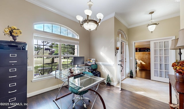 home office featuring wood-type flooring, ornamental molding, and a chandelier