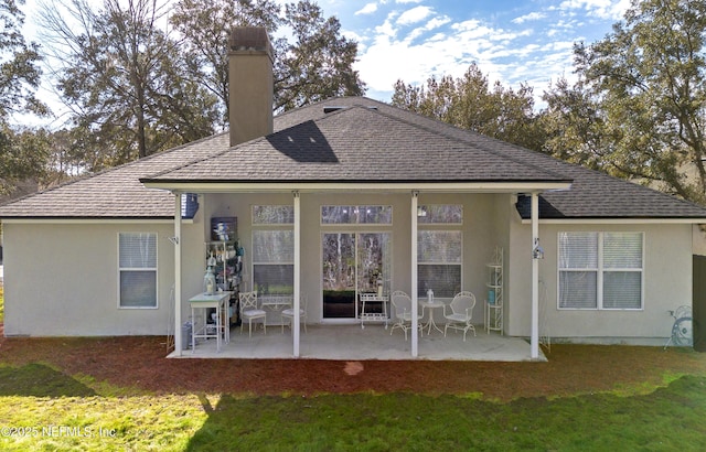 back of house with a yard and a patio area