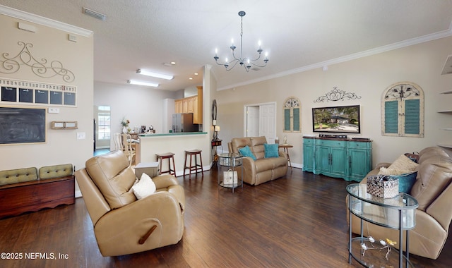 living room with a textured ceiling, dark wood-type flooring, ornamental molding, and a chandelier