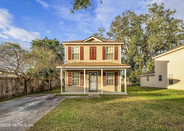 view of property with covered porch and a front lawn