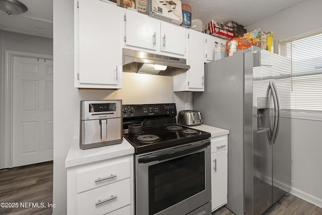 kitchen featuring dark hardwood / wood-style flooring, white cabinetry, appliances with stainless steel finishes, and a textured ceiling