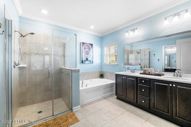 bathroom with tile patterned floors, a textured ceiling, ornamental molding, vanity, and independent shower and bath