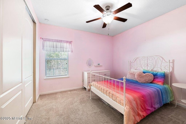 bedroom featuring ceiling fan and carpet