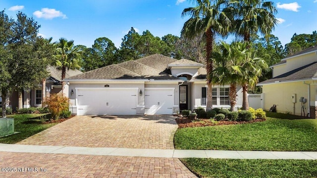 view of front facade with a garage and a front lawn