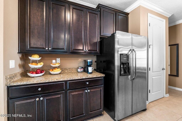 kitchen with light stone counters, stainless steel fridge with ice dispenser, ornamental molding, and dark brown cabinetry