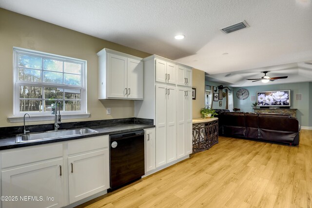 54110 Marlee Rd, Callahan, FL 32011 - kitchen featuring sink, white cabinetry, black dishwasher, a textured ceiling, and light wood-type flooring
