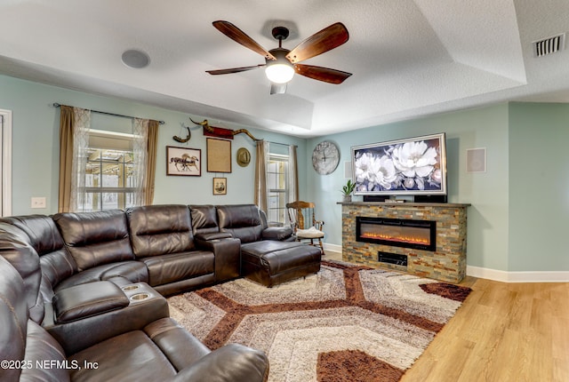 54110 Marlee Rd, Callahan, FL 32011 - living room with a fireplace, wood-type flooring, a tray ceiling, and a textured ceiling