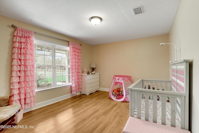 54110 Marlee Rd, Callahan, FL 32011 - bedroom with a textured ceiling and light hardwood / wood-style flooring