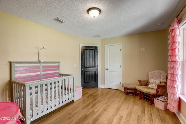 54110 Marlee Rd, Callahan, FL 32011 - bedroom featuring light hardwood / wood-style floors and a textured ceiling