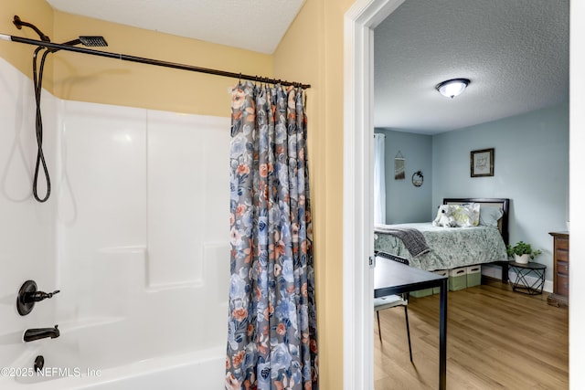 54110 Marlee Rd, Callahan, FL 32011 - bathroom with wood-type flooring, shower / tub combo, and a textured ceiling