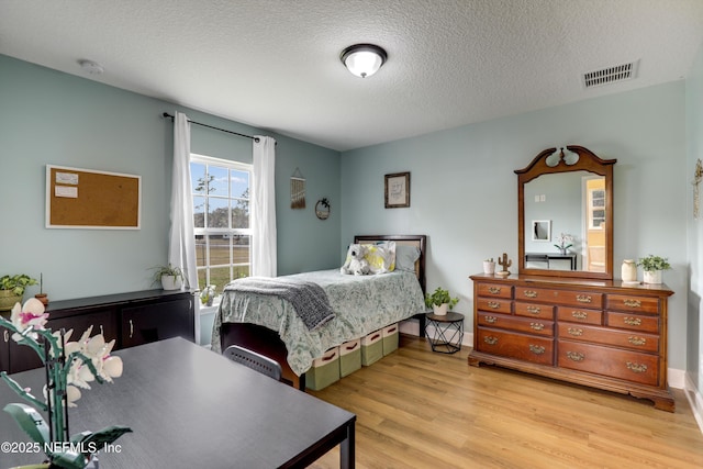 54110 Marlee Rd, Callahan, FL 32011 - bedroom featuring a textured ceiling and light wood-type flooring