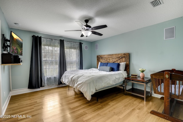 54110 Marlee Rd, Callahan, FL 32011 - bedroom with ceiling fan, a textured ceiling, and light hardwood / wood-style floors