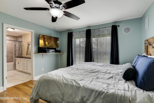 54110 Marlee Rd, Callahan, FL 32011 - bedroom with ensuite bathroom, ceiling fan, a textured ceiling, and light hardwood / wood-style flooring