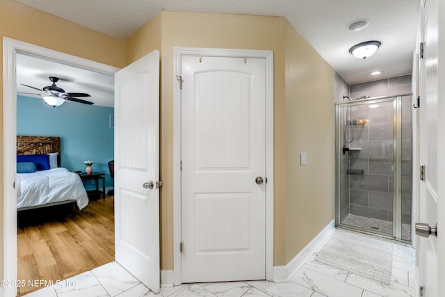 54110 Marlee Rd, Callahan, FL 32011 - bathroom featuring walk in shower, ceiling fan, and a textured ceiling