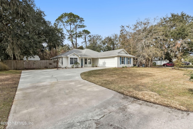 ranch-style house featuring a garage and a front yard