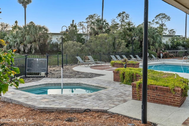 view of pool featuring a patio and a community hot tub