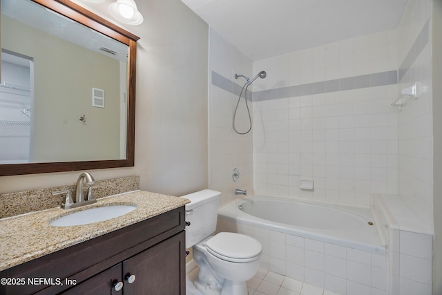 full bathroom with vanity, tiled shower / bath, tile patterned flooring, and toilet