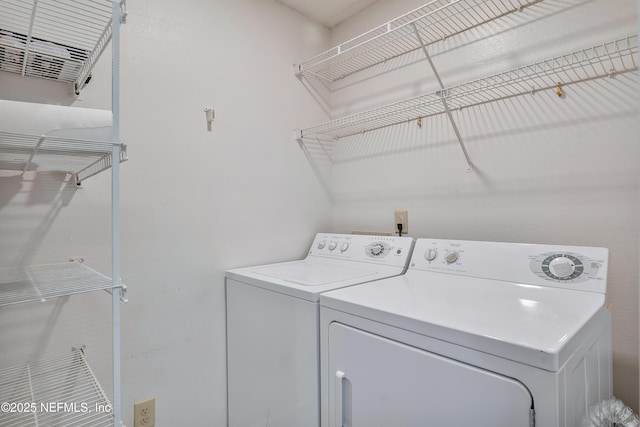 washroom with washing machine and clothes dryer