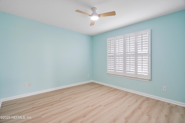 empty room with ceiling fan and light hardwood / wood-style flooring