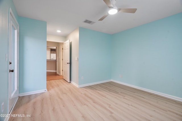 spare room with ceiling fan and light wood-type flooring