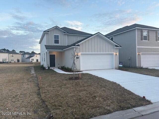 view of front of property featuring a garage and a front lawn