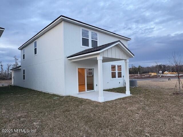 back of house with a yard, a patio, and central air condition unit