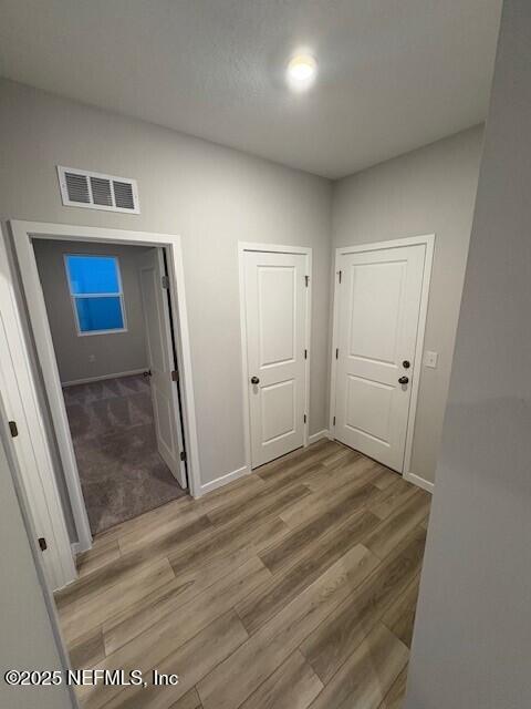 corridor featuring hardwood / wood-style flooring