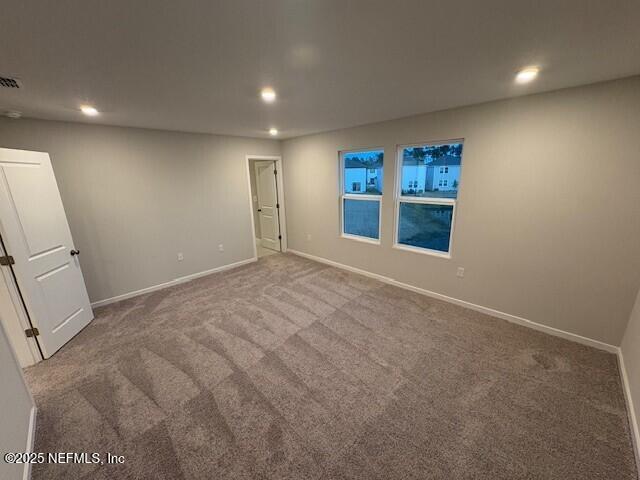 spare room featuring carpet floors