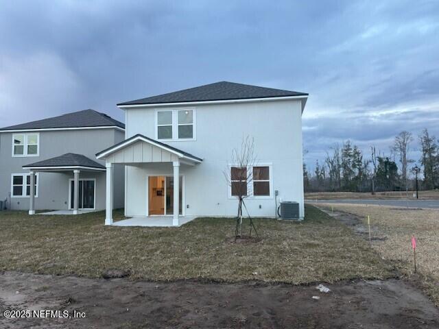 rear view of house with a patio area and a lawn