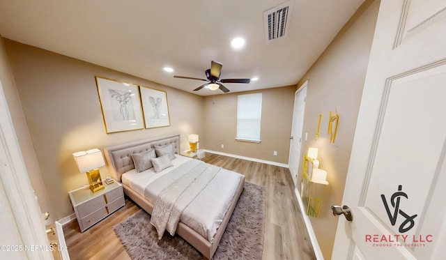 bedroom with ceiling fan and light wood-type flooring